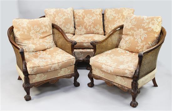 An Edwardian carved mahogany double caned bergere suite,